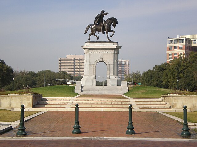 Sign of the University of Texas - Austin and Tower in the background