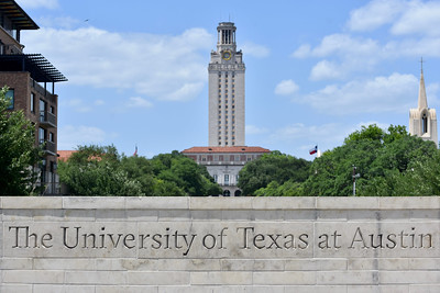 Sign of the University of Texas - Austin and Tower in the background